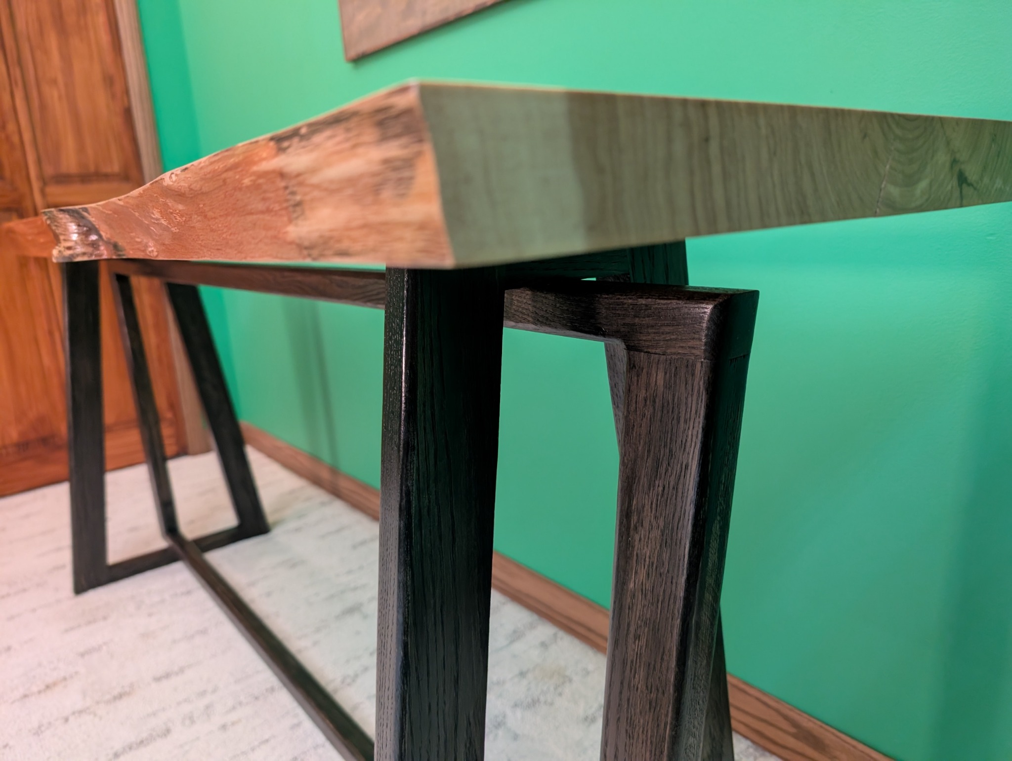 Close view of the interlocking trapezoidal base beneath the hickory slab
